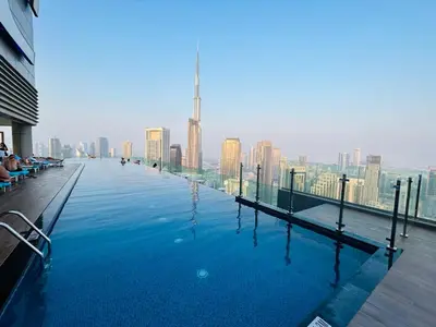 a swimming pool with a view of a city skyline at Unique 2br with Infinity Pool view on Burj Khalifa in Dubai