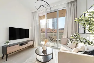 a living room with a tv and a couch at Silkhaus awesome 1BDR in Opera District in Dubai