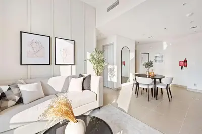 a living room with a white couch and a table at Silkhaus awesome 1BDR in Opera District in Dubai