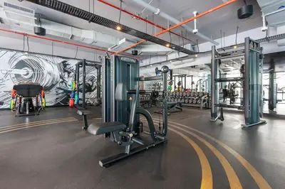 a gym with several treadmills and machines at StoneTree - Best Rate Studio in Dubai Marina in Dubai