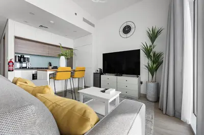 a living room with a couch and a tv at StoneTree - Best Rate Studio in Dubai Marina in Dubai