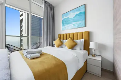 a bedroom with a large bed with a large window at StoneTree - Best Rate Studio in Dubai Marina in Dubai