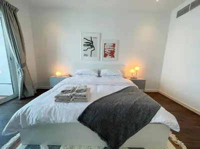 a bedroom with a white bed with towels on it at Deluxe - Amazing views - Elite in Dubai