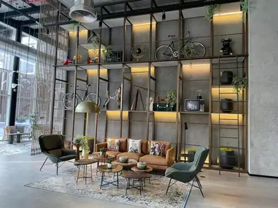 a living room with a couch and tables and chairs at Oraya - Apt. With Skyline and Garden View Along With City in Dubai