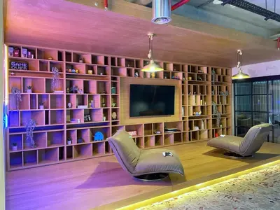 a living room with two chairs and a television at Oraya - Apt. With Skyline and Garden View Along With City in Dubai