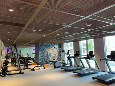 a gym with treadmills and elliptical machines at Oraya - Apt. With Skyline and Garden View Along With City in Dubai