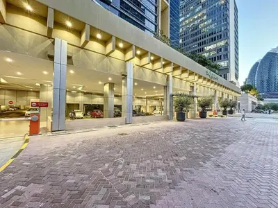 a large building with lights on the side of it at Nasma Luxury Stays - Elegant 1BR With Stunning View of Park Avenue in Dubai