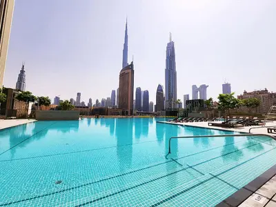 a large swimming pool in the middle of a city at RH - Beautiful Burj Khalifa View, 03BR with Maid's Room, 7 mins walk to Dubai Mall in Dubai