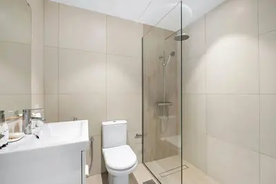 a bathroom with a shower and a toilet and a sink at Cozy Dubai Marina Design Studio close to Jumeirah Beach, Mall & Metro in Dubai