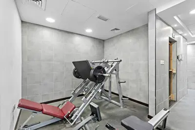 a gym with a red treadmill in a room at Cozy Dubai Marina Design Studio close to Jumeirah Beach, Mall & Metro in Dubai