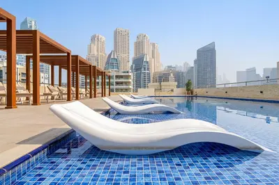 a pool with two white slides on the roof of a building at Cozy Dubai Marina Design Studio close to Jumeirah Beach, Mall & Metro in Dubai