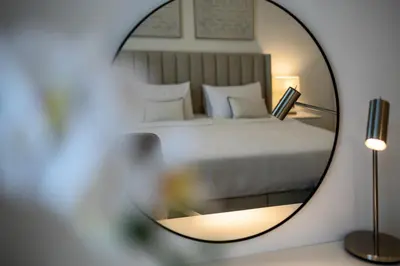 a mirror reflecting a bed in a bedroom at Splendid brand new 1BD apartment near the beach in Dubai