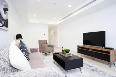 a living room with a flat screen tv and a couch at Vibrant - Prime Location Dubai Marina - Near Metro in Dubai