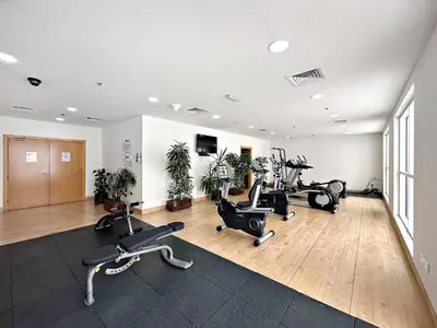 a gym with treadmills and exercise bikes in a room at Silkhaus New studio in Silicon Oasis ASB Tower in Dubai