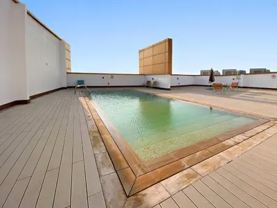 a swimming pool on the roof of a building at Silkhaus New studio in Silicon Oasis ASB Tower in Dubai