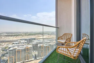 a balcony with two chairs and a view of a city at STAY BY LATINEM Luxury 1BR Holiday Home W 2709 Near Burj Khalifa in Dubai