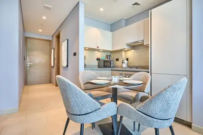 a kitchen and dining room with a table and chairs at STAY BY LATINEM Luxury 1BR Holiday Home W 2709 Near Burj Khalifa in Dubai