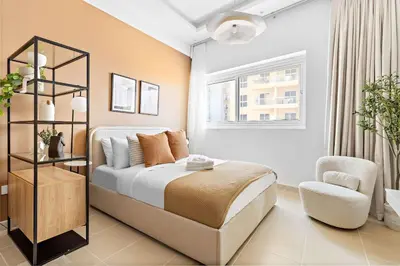 a bedroom with a bed and a chair and a window at Silkhaus New Studio in ASB Tower Walking distance to mall in Dubai