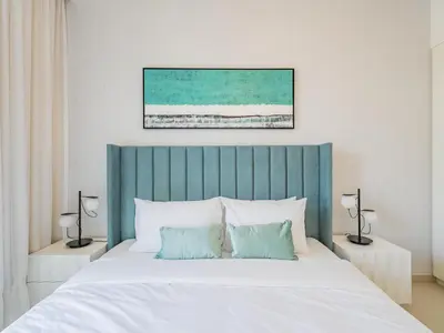 a bed with a blue headboard in a bedroom at Blazing 1Br in Downtown Views in Dubai
