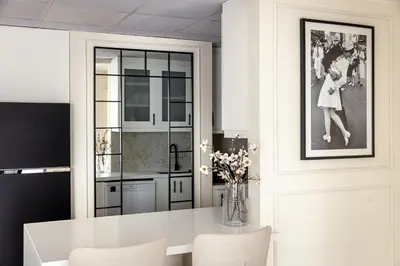 a kitchen with a white table and chairs at Luxury 1 bedroom with beautiful marina view! in Dubai