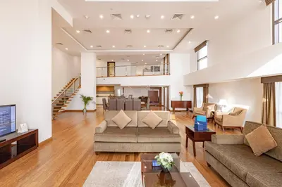 a living room with couches and a dining room at Roda Amwaj Suites Jumeirah Beach Residence in Dubai