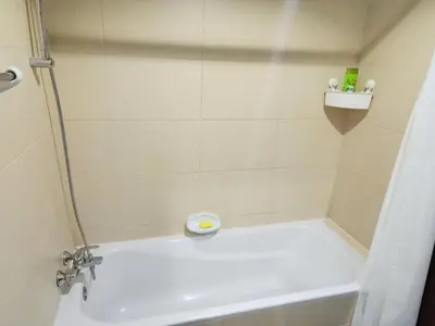 a bathroom with a shower with a white tub at Elite 6 Residence - Sports City by Golden Casa in Dubai