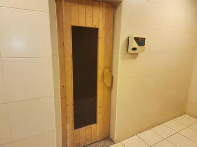 a wooden door in a bathroom with a wall at Elite 6 Residence - Sports City by Golden Casa in Dubai