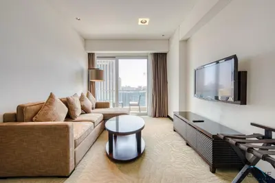 a living room with a couch and a flat screen tv at Overlooking Marina Views Next to Marina Mall 1BR Unit, The Address Residences, Dubai Marina by Deluxe Holiday Homes in Dubai