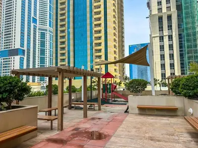a patio in a city with benches and buildings at 54 Floor Palm & Sea View Dubai Marina. LUX / NEW in Dubai