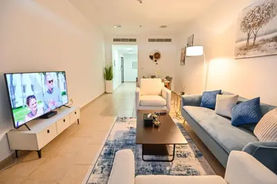 a living room with a couch and a flat screen tv at 54 Floor Palm & Sea View Dubai Marina. LUX / NEW in Dubai