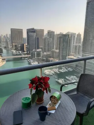 a table on a balcony with a view of a city at Coliving sharing Hostel 1 in Dubai