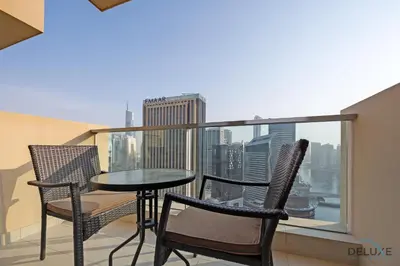 a balcony with a table and chairs and a view of the city at Urban Studio at The Address Residences Dubai Marina by Deluxe Holiday Homes in Dubai
