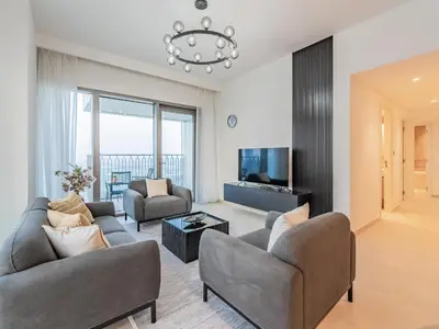 a living room with two couches and a chandelier at Phenomenal 2Br in Downtown Views II in Dubai