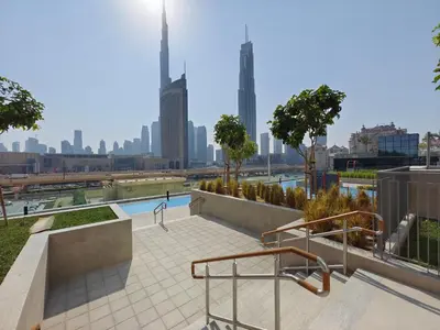 a swimming pool with a city skyline in the background at Phenomenal 2Br in Downtown Views II in Dubai