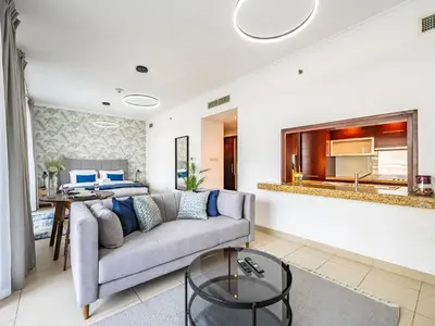 a living room with a couch and a bed at Incredible Studio In Burj View in Dubai
