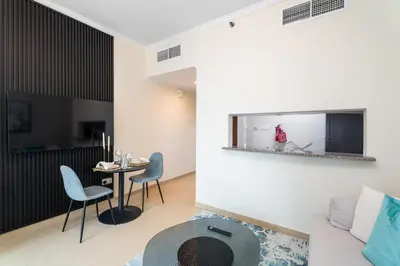 a living room with a couch and a table at Nasma Luxury Stays - Sophisticated Studio Apt with Stunning Marina View in Dubai