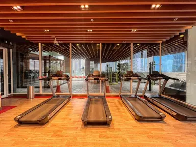 a gym with several treadmills in a building at GuestReady - Lavish studio with Burj Khalifa views in Dubai