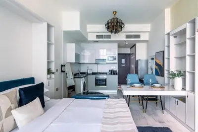 a living room with a white couch and a table at GuestReady - Lavish studio with Burj Khalifa views in Dubai