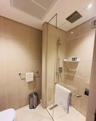 a bathroom with a shower and a toilet at Dubai Marina Gate 2 Deluxe Apartment in Dubai