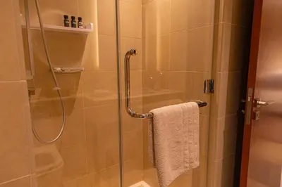 a bathroom with a shower with a glass door at Dubai Marina Gate 2 Deluxe Apartment in Dubai