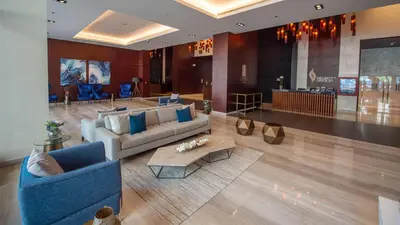 a lobby with two couches and a table in a building at Dubai Marina Gate 2 Deluxe Apartment in Dubai