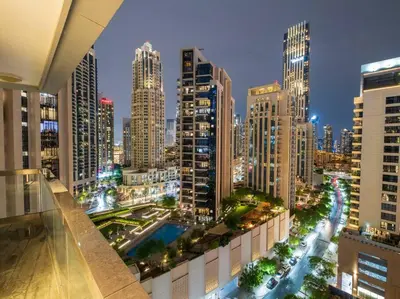 a view of a city at night with tall buildings at FIRST CLASS 2BR with Full Boulevard View in Dubai