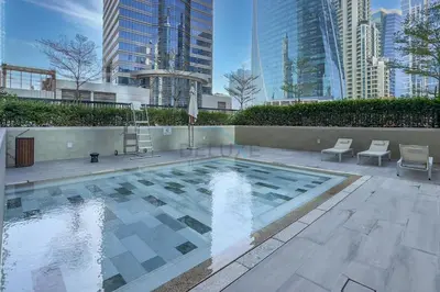 a swimming pool in a city with tall buildings at Special Deal Scenic 1BR Close to Burj Khalifa by Deluxe Holiday Homes in Dubai