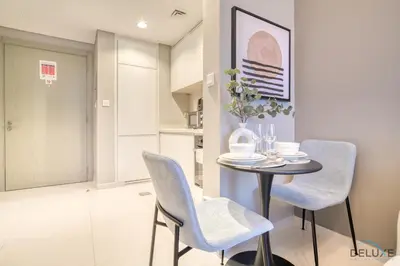a dining room with a table and two chairs at Special Deal Scenic 1BR Close to Burj Khalifa by Deluxe Holiday Homes in Dubai