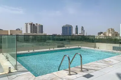 a swimming pool on the roof of a building at Frank Porter - Regina Tower in Dubai