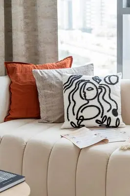 a white couch with pillows on top of it at Frank Porter - Regina Tower in Dubai