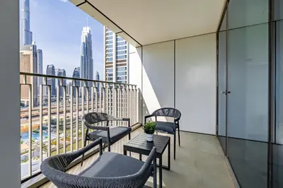 a balcony with chairs and a view of the city at 3BDR with Maid Room I Downtown I Burj Khaliva View in Dubai