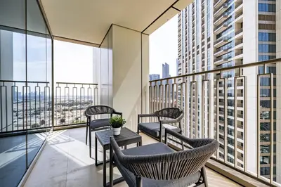 a balcony with chairs and tables on a building at 3BDR with Maid Room I Downtown I Burj Khaliva View in Dubai
