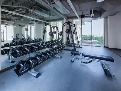 a gym with a lot of treadmills and machines at Pleasant 2BD new apartment in Dubai Creek Harbour in Dubai