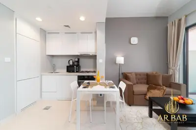 a kitchen and living room with a table and a couch at Arbab Homes Luxury 1BR- Canal View - Damac Zada Tower in Dubai